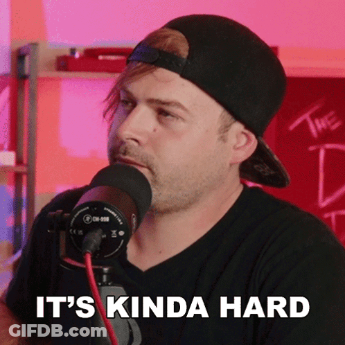 A Man Speaking Into A Microphone With The Words " It 'S Kinda Hard " Above Him GIF
