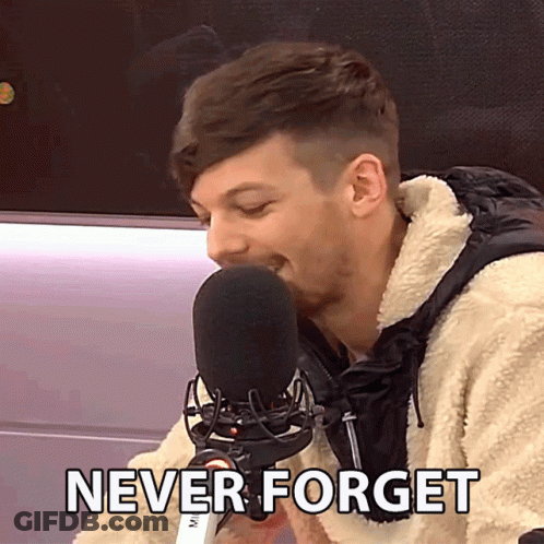 A Man Speaking Into A Microphone With The Words " Never Forget " Written Below Him GIF