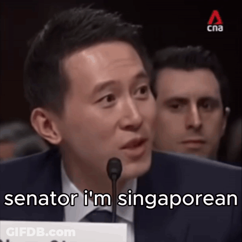 A Man Speaking Into A Microphone With The Words " Senator I 'M Singaporean " Written Below Him GIF
