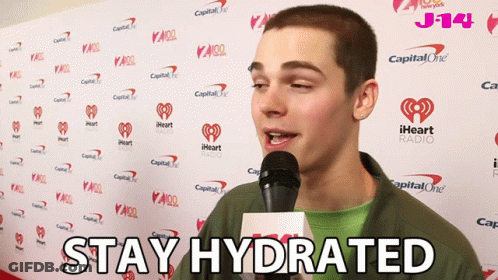 A Man Speaking Into A Microphone With The Words " Stay Hydrated " On The Bottom GIF