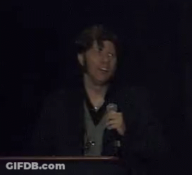 A Man Speaking Into A Microphone With The Words Voidmerch Written Below Him GIF