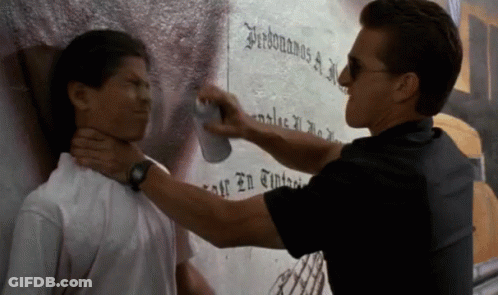 A Man Spraying Another Man 'S Neck With A Can Of Spray GIF