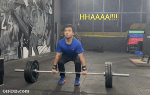 A Man Squatting Down Holding A Barbell With The Word Hhaaaa !!! Above Him GIF