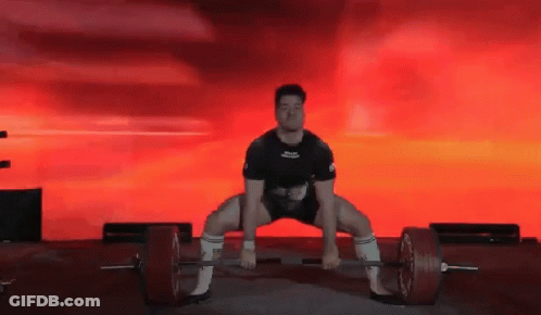 A Man Squatting Down With A Barbell In Front Of A Red Background That Says ' Powerlifting ' On It GIF
