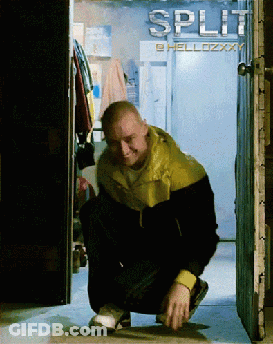 A Man Squatting In Front Of A Sign That Says Split On It GIF