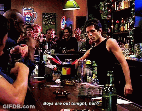 A Man Standing At A Bar With A Sign That Says Beer On Tap On It GIF