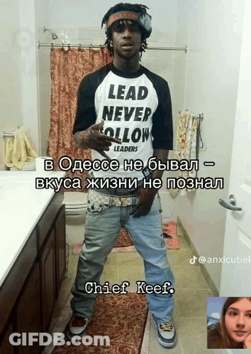 A Man Standing In A Bathroom Wearing A Lead Never Follow Shirt GIF