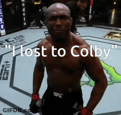 A Man Standing In A Boxing Ring With The Words " I Lost To Colby " On The Bottom GIF
