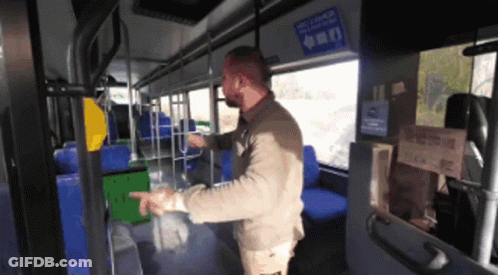 A Man Standing In A Bus With A Sign On The Wall That Says " Recycle Here " GIF