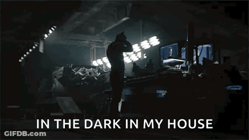 A Man Standing In A Dark Room With The Words In The Dark In My House Above Him GIF