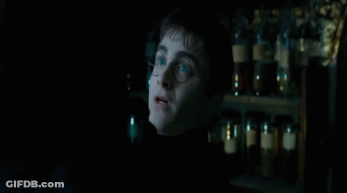 A Man Standing In A Dark Room With The Words " Ttene " On The Bottom GIF
