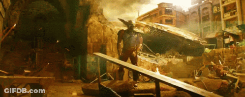 A Man Standing In A Destroyed City With A Sign That Says ' 00000 ' GIF