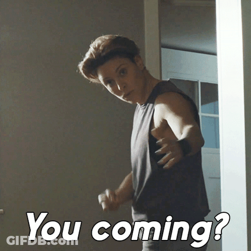 A Man Standing In A Doorway With The Words " You Coming " On The Bottom Right GIF