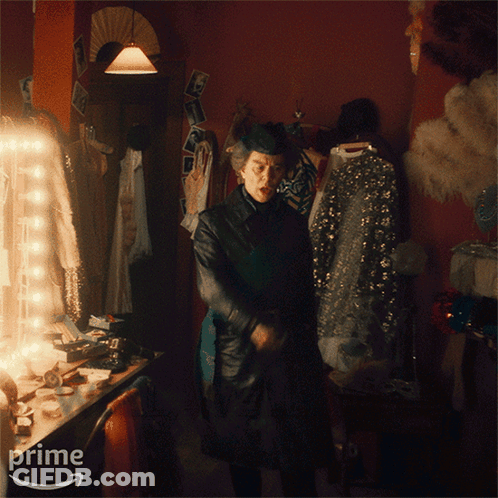 A Man Standing In A Dressing Room With The Words We Prime On The Bottom GIF