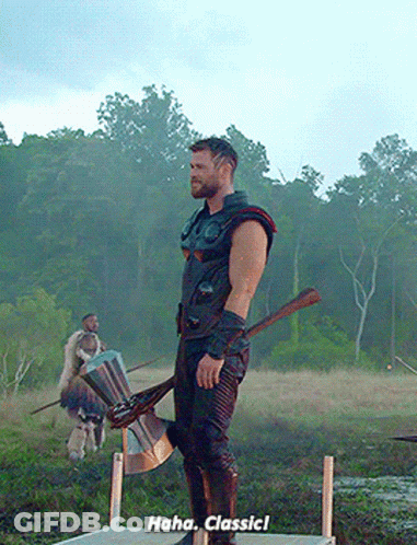 A Man Standing In A Field Holding An Axe And A Shield Says " Haha Classic ! " GIF