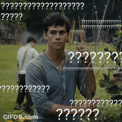A Man Standing In A Field With A Bunch Of White Letters That Say ' ?? ' GIF