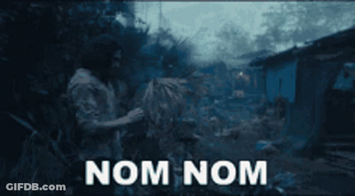 A Man Standing In A Field With The Words Nom Nom Written On The Screen GIF