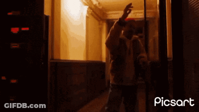 A Man Standing In A Hallway With The Words Blockchain Welcome In Written On The Bottom GIF