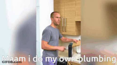 A Man Standing In A Kitchen With The Words Maam I Do My Own Plumbing GIF