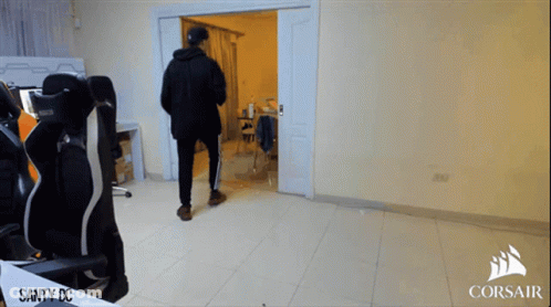 A Man Standing In A Room With Corsair Written On The Bottom GIF