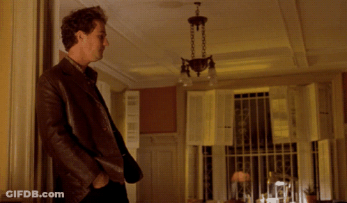 A Man Standing In A Room With The Words " Don 'T Tease Me " Written Above Him GIF