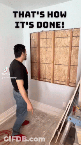 A Man Standing In A Room With The Words That 'S How It 'S Done On The Top GIF