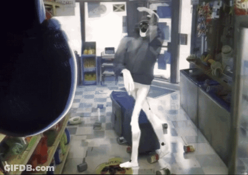 Man Standing In Store With Candy Sign GIF