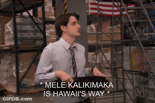 A Man Standing In A Warehouse With The Words Mele Kaliimaka Is Hawaii 'S Way GIF