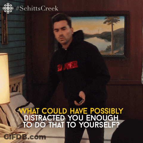 A Man Standing In Front Of A Bed With The Words What Could Have Possibly Distracted GIF