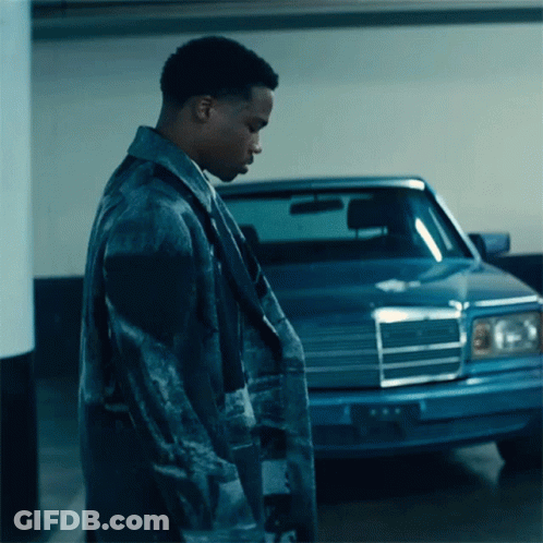 A Man Standing In Front Of A Blue Mercedes GIF