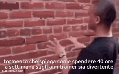 A Man Standing In Front Of A Brick Wall With The Words Tormento Che Spiega GIF
