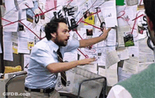 A Man Standing In Front Of A Bulletin Board With Papers On It Including One That Says Pepe GIF