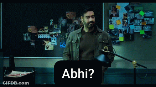 A Man Standing In Front Of A Bulletin Board With The Word Abhi On It GIF