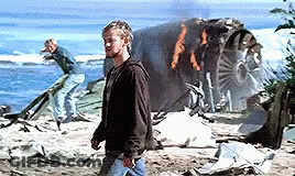 A Man Standing In Front Of A Burning Plane GIF