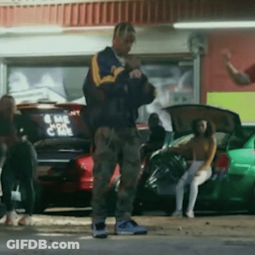 A Man Standing In Front Of A Car That Says Come On GIF