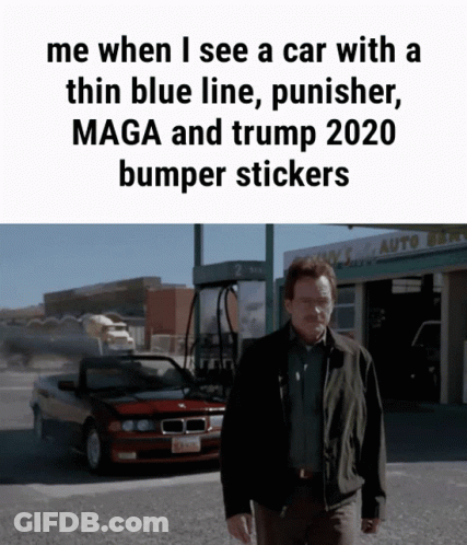 A Man Standing In Front Of A Car With A Thin Blue Line Punisher Maga And Trump 2020 Bumper Stickers On It GIF