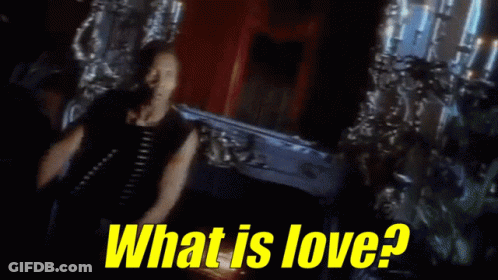 Man Standing In Front Of Coffin With What Is Love GIF
