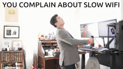 A Man Standing In Front Of A Computer With The Words You Complain About Slow Wifi GIF