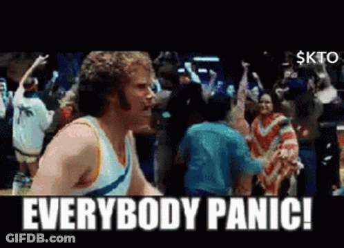 A Man Standing In Front Of A Crowd With The Words Everybody Panic GIF