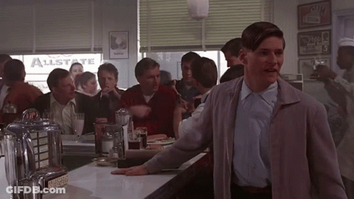 A Man Standing In Front Of A Diner With A Sign That Says Allstate On It GIF