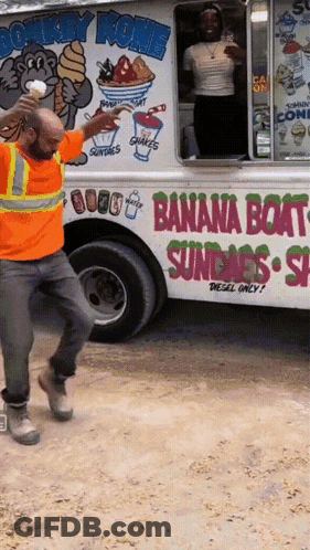 A Man Standing In Front Of A Donkey Kong Banana Boat Ice Cream Truck GIF