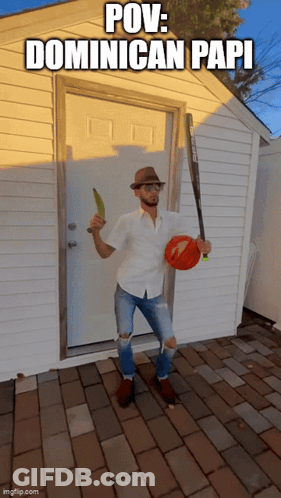 A Man Standing In Front Of A Door Holding A Baseball Bat And A Banana GIF