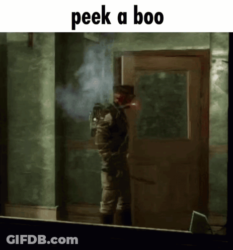 A Man Standing In Front Of A Door With The Words Peek A Boo On The Bottom GIF