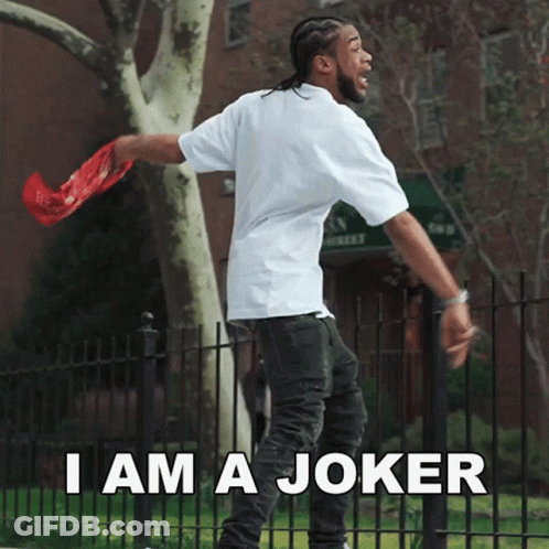 A Man Standing In Front Of A Fence With The Words " I Am A Joker " GIF