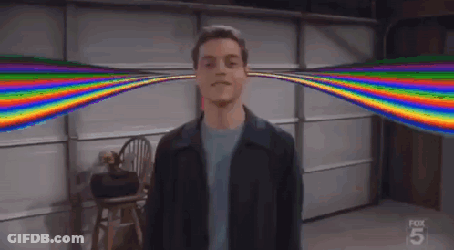 A Man Standing In Front Of A Garage Door With A Rainbow Coming Out Of His Ears . GIF