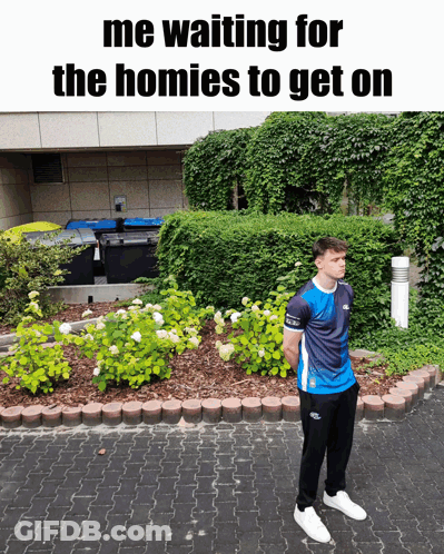 A Man Standing In Front Of A Garden With The Words " Me Waiting For The Homies To Get On " Above Him GIF