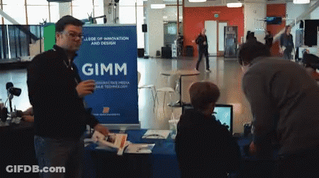 A Man Standing In Front Of A Gimm Sign GIF