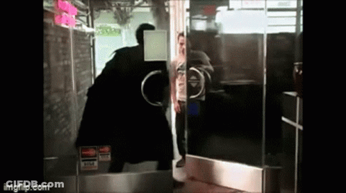 A Man Standing In Front Of A Glass Door With A Visa Sticker On It GIF
