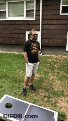 A Man Standing In Front Of A House Wearing A T-Shirt That Says " I 'M A Scout " GIF