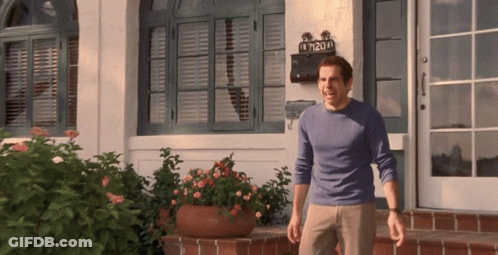 A Man Standing In Front Of A House With A Mailbox That Says 7120 GIF